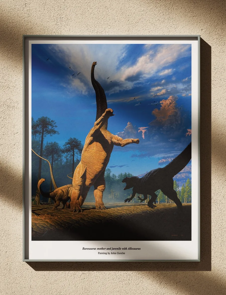 The Barosaurus painting, framed in black on a warm plaster wall, lit from the side by afternoon sun.